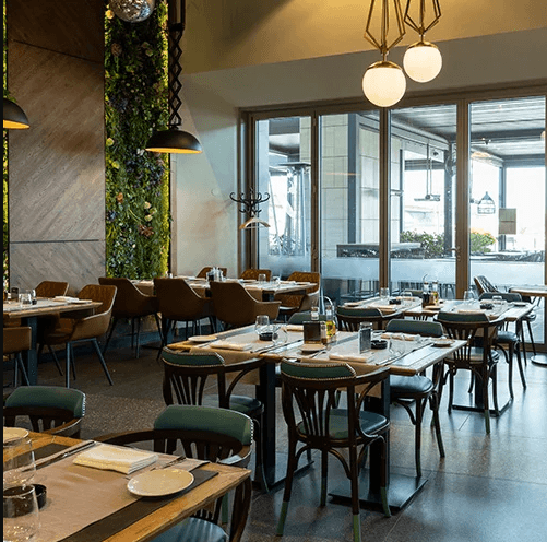 A warmly lit restaurant dining room set for evening service
